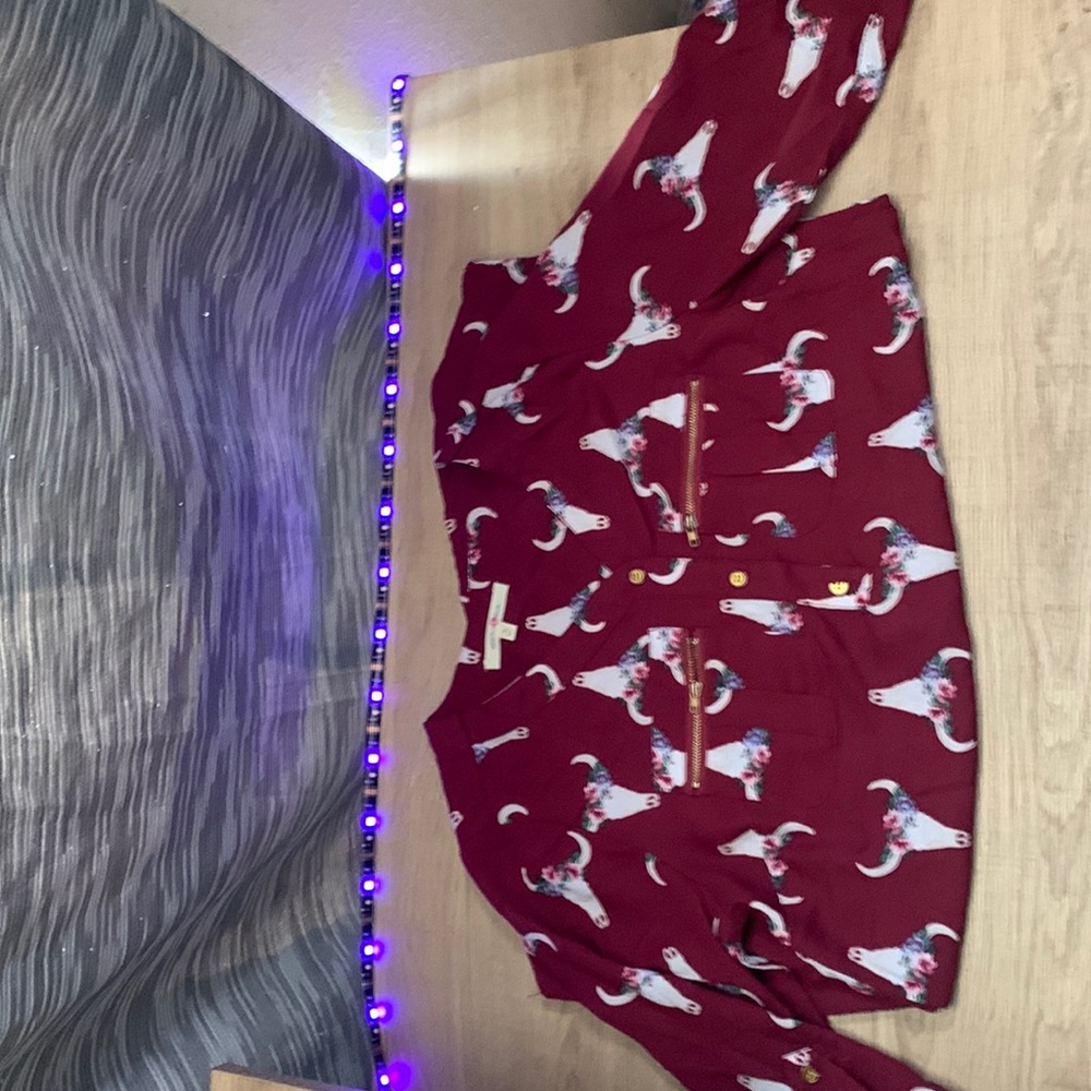 Cute maroon blouse with cow skulls and flowers.